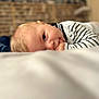 Maël a rejoint le concours — aidez-le/la à gagner de superbes lots ! baby, infant, face, hand, fingers, lying_down, striped_clothing, soft_focus, blurred_background, indoor, child, cute, portrait, person, skin, blond_hair, young, resting, calm, closeup