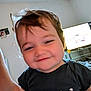 Gabriel a rejoint le concours — aidez-le/la à gagner de superbes lots ! child, toddler, smiling, portrait, indoor, black_shirt, panda_print, hair, face, person, television, furniture, arm, candid, happy, room, home, light, casual, cute