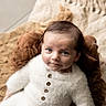 baby, infant, child, face, blue_eyes, white_clothing, buttoned_sweater, knit_blanket, brown_blanket, soft_texture, portrait, indoors, cute, cozy, newborn, looking_up, sitting, curious, head, photography