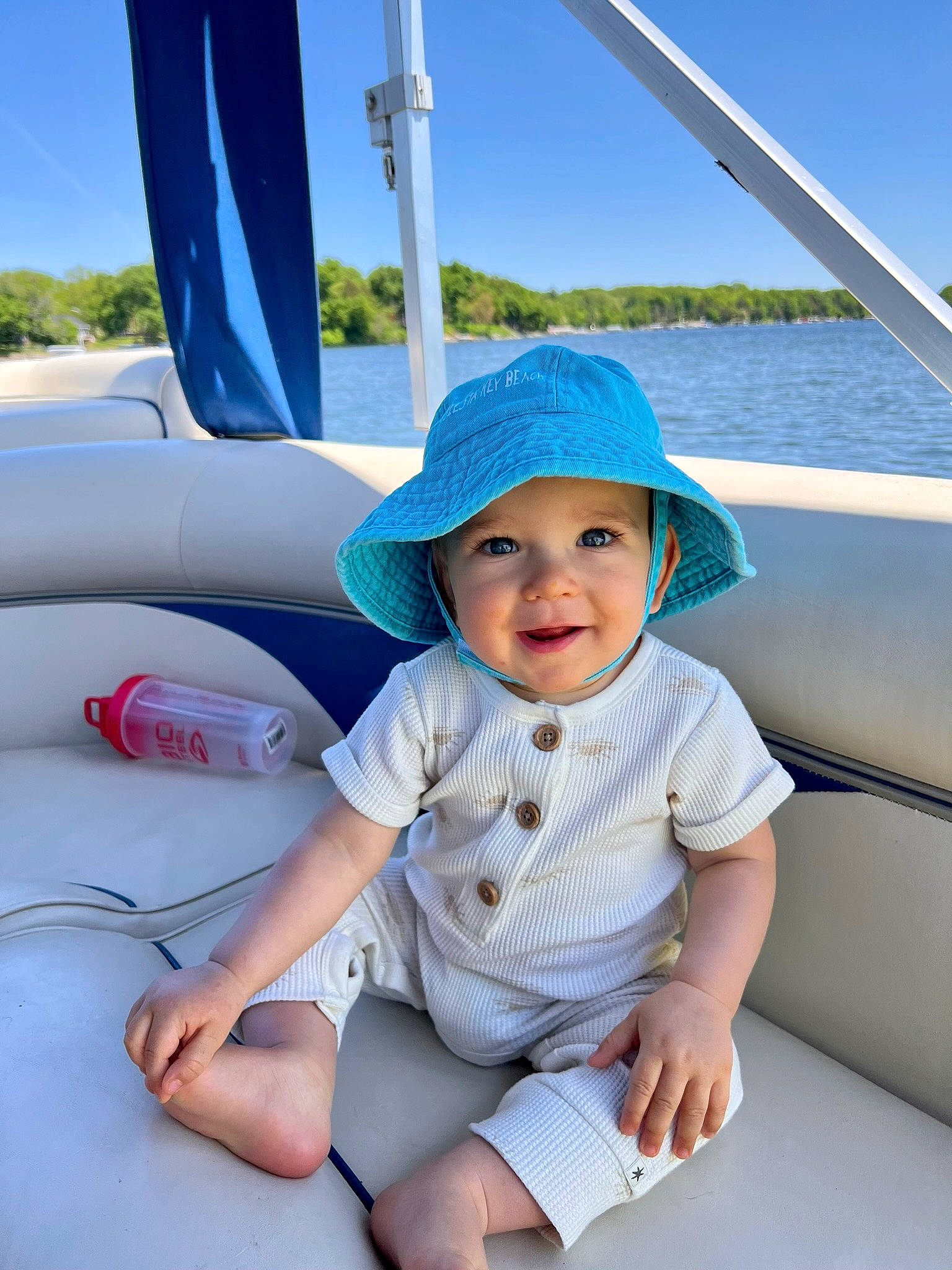 Joey is registered to the contest to win money with this photo: azure, baby, baby_toddler_clothing, blue, cap, comfort, electric_blue, fashion_accessory, fun, hat, headwear, joy, leisure, person, recreation, shade, sky, summer, sun_hat, toddler