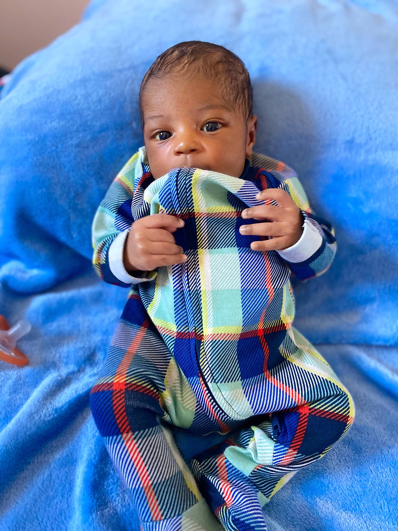 Chozyn is registered to the contest to win money with this photo: azure, baby, baby_toddler_clothing, child, comfort, electric_blue, finger, fun, gesture, hand, happy, outerwear, pattern, person, plaid, product, sleeve, tartan, textile, thumb