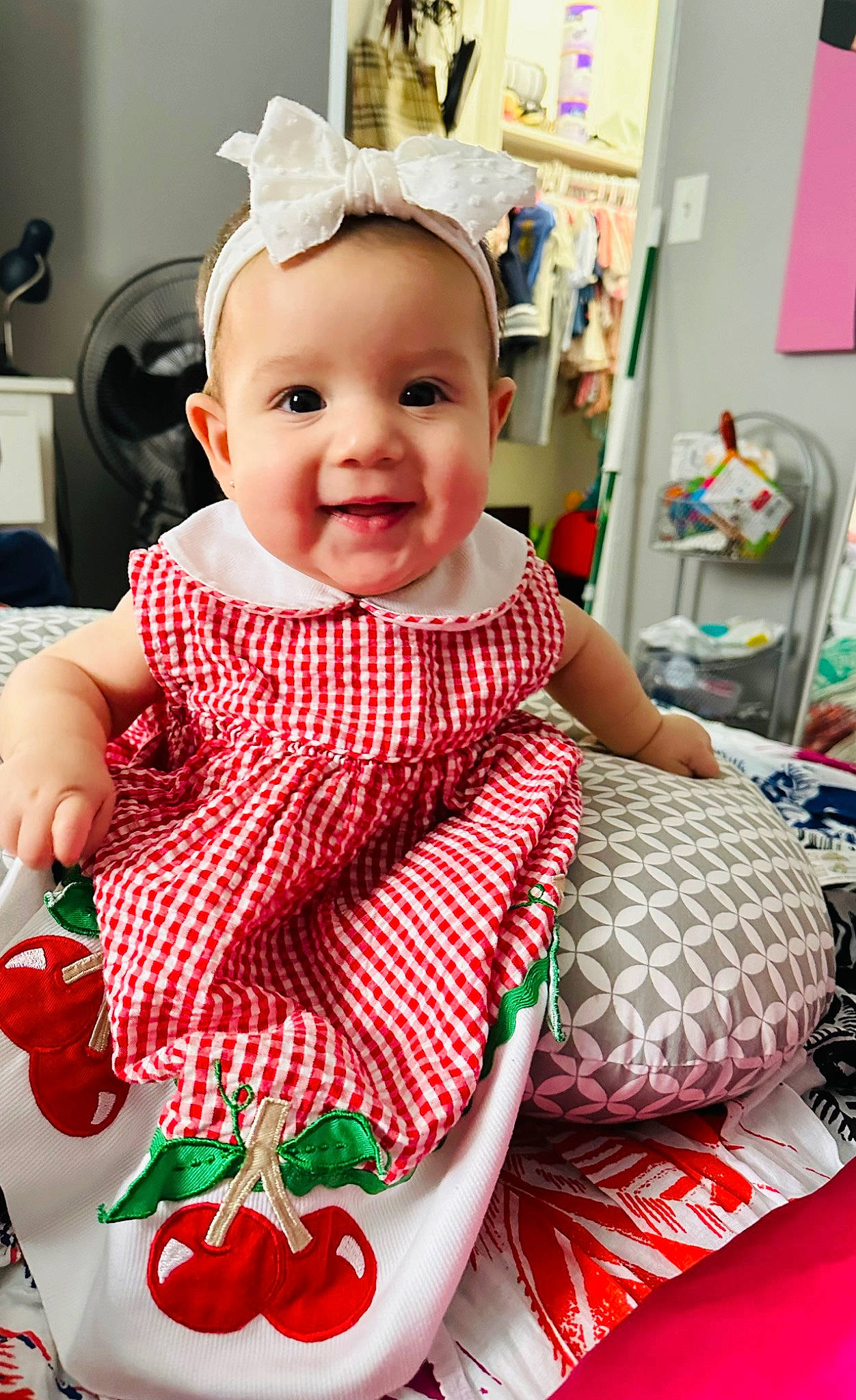 Noelani is registered to the contest to win money with this photo: baby, baby_toddler_clothing, carmine, cheek, child, clothing, event, green, happy, head, holiday, joy, pattern, person, product, shelf, sitting, skin, sleeve, smile