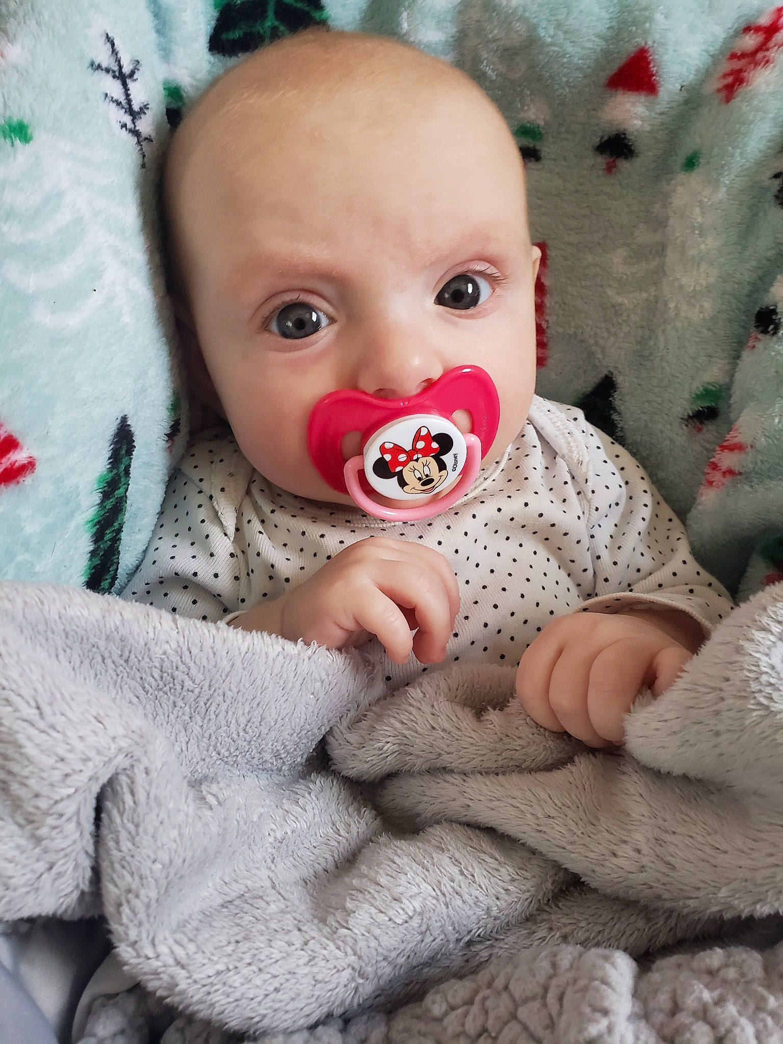 Logan is registered to the contest to win money with this photo: baby, cheek, child, eye, face, facial_expression, hand, head, lip, mouth, nose, person, pink, play, skin, smile, toddler, toy