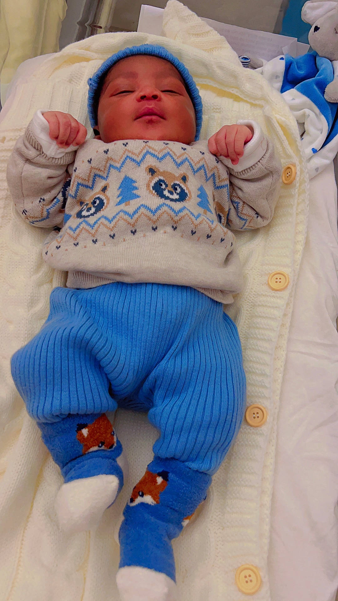 baby, bed, blanket, bonnet, cap, clothing, cradle, crib, face, furniture, glove, hat, head, infantbed, knitwear, newborn, person, photography, portrait, sweater