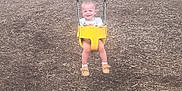 Kadence is registered to the contest to win money with this photo: baby_shoes, child, fun, happy, joy, metal_chains, nature, outdoor, person, play, playground, seat, shorts, smiling, swing, toddler, tshirt, white_socks, wood_chips, yellow_swing
