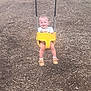 child, toddler, swing, playground, yellow_swing, smiling, happy, outdoor, wood_chips, baby_shoes, white_socks, shorts, tshirt, play, fun, joy, person, seat, metal_chains, nature