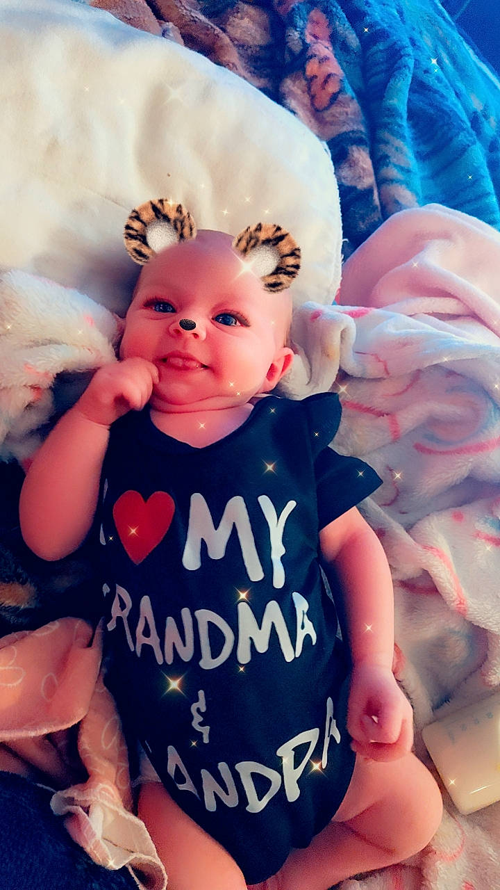 baby, bed, blanket, bodypart, clothing, cushion, doll, face, finger, furniture, glove, hand, head, homedecor, newborn, person, photography, portrait, t_shirt, toy