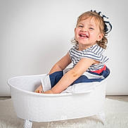 Sybille participe au concours pour gagner de l'argent avec cette photo : toddler, child, smiling, striped_clothing, beret, white_tub, clawfoot_tub, curly_hair, happy, sitting, portrait, studio, white_background, floor_rug, cute, playful, cheerful, indoor, person, baby