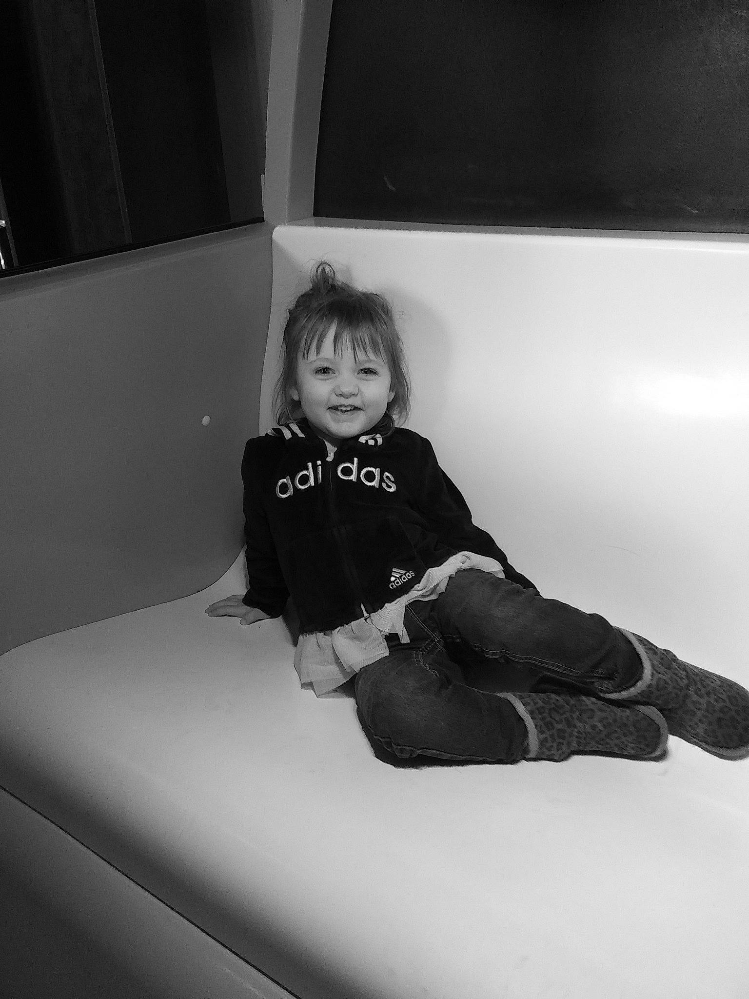 Ayva is registered to the contest to win money with this photo: black, black_and_white, child, eye, joy, leg, monochrome, monochrome_photography, person, photograph, photography, portrait_photography, sitting, smile, style, toddler, white