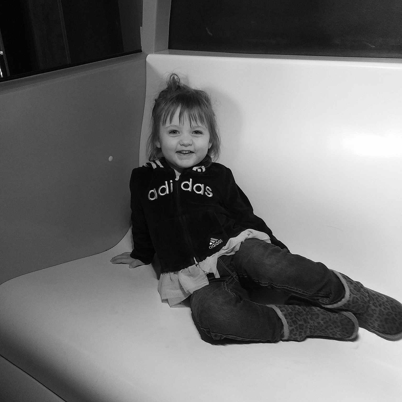 Ayva is registered to the contest to win money with this photo: black, black_and_white, child, eye, joy, leg, monochrome, monochrome_photography, person, photograph, photography, portrait_photography, sitting, smile, style, toddler, white