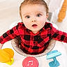 baby, blue_eyes, checkered_shirt, child, curious, cute, expression, face, hands, indoor, infant, music_button, person, playtime, plush, red_shirt, seat, toy, walker, young_child