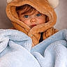 baby, bear_hood, blanket, blue_blanket, blue_eyes, cheeks, child, cozy, cute, face, fur, gaze, hood, indoor, infant, long_eyelashes, plush, portrait, soft_texture, wrapped