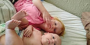 Elizabeth joined the competition — help win amazing prizes! baby, bed, bedroom, blanket, calm, child, curious, diaper, face, family, hair, indoor, lying_down, person, pillow, pink_shirt, resting, sibling, skin, young