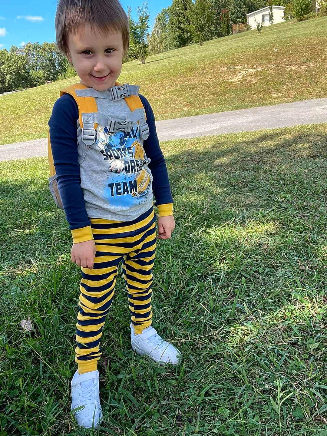 Karter is registered to the contest to win money with this photo: baby_toddler_clothing, child, electric_blue, fun, grass, grass_family, grassland, happy, joy, knee, meadow, pattern, people_in_nature, person, plant, sky, sleeve, smile, sportswear, t_shirt