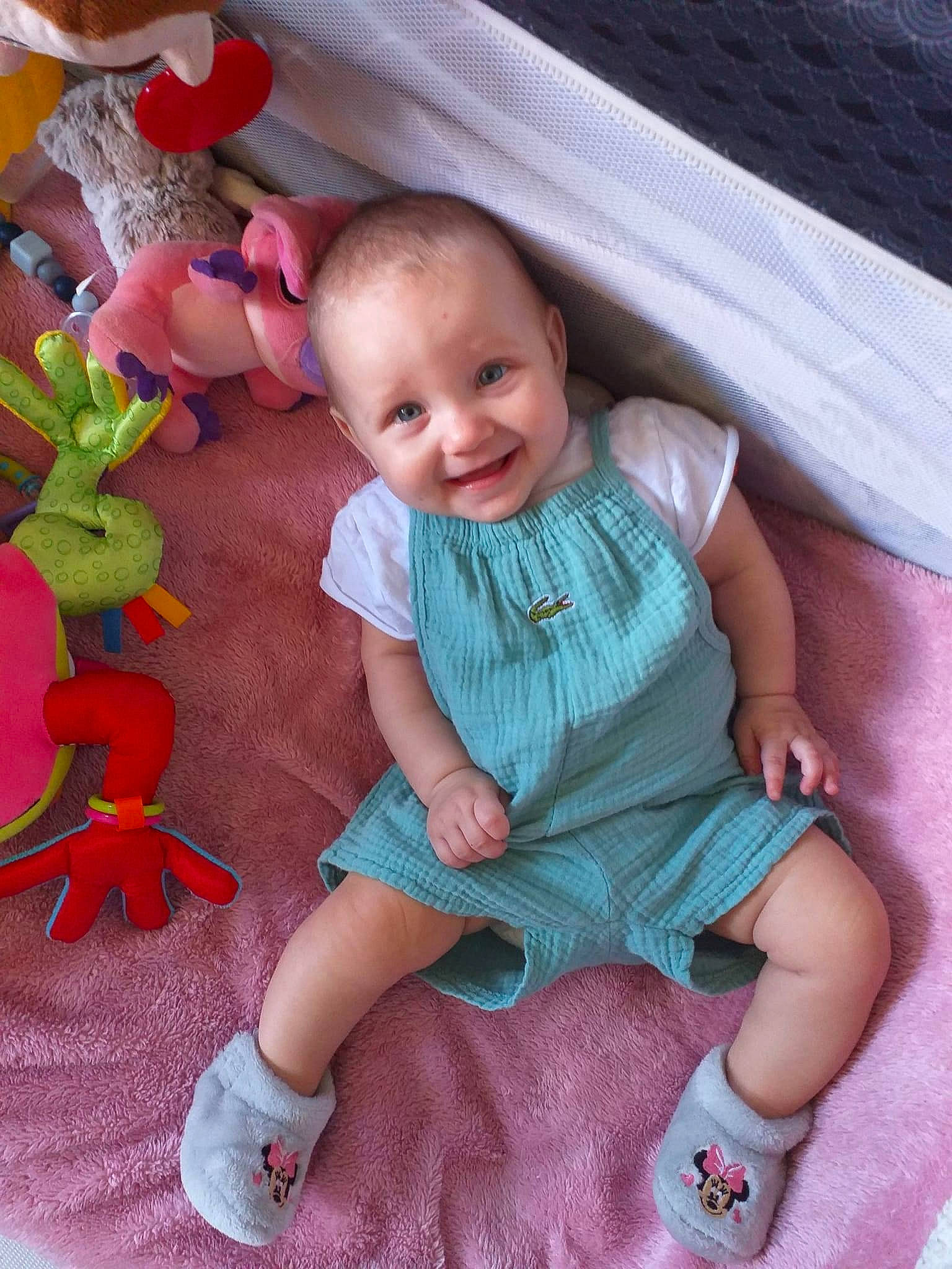 Malya participe au concours pour gagner de l'argent avec cette photo : baby, baby_toddler_clothing, child, dress, fun, grass, happy, iris, joy, lap, magenta, pattern, person, pink, plant, sitting, skin, smile, sock, textile