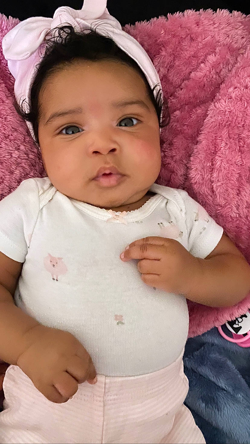 Legacy is registered to the contest to win money with this photo: baby_toddler_clothing, cap, cheek, child, chin, eyebrow, eyelash, finger, gesture, happy, headgear, iris, lip, neck, nose, person, pink, skin, sleeve, toddler