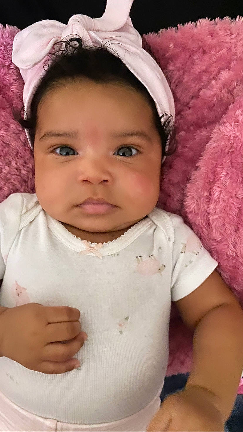 Legacy is registered to the contest to win money with this photo: baby, baby_toddler_clothing, cheek, chin, eye, eyebrow, eyelash, face, gesture, happy, head, iris, lip, mouth, nose, person, pink, skin, sleeve, toddler