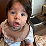 Josiah is registered to the contest to win money with this photo: baby, child, infant, face, eyes, bib, clothing, expression, indoor, human, person, skin, hair, mouth, hand, fabric, seat, floor, blanket, curiosity