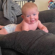 Alexander joined the competition — help win amazing prizes! baby, child, diaper, smiling, tongue_out, couch, blanket, indoor, furniture, cozy, face, skin, happy, young, infant, cute, living_room, household, relaxing, comfort