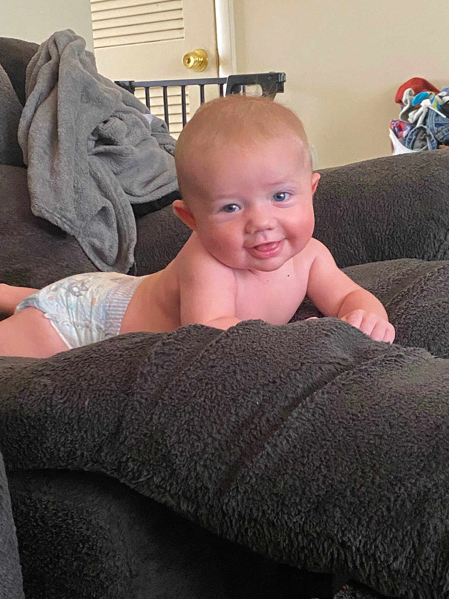 Alexander joined the competition — help win amazing prizes! baby, child, diaper, smiling, tongue_out, couch, blanket, indoor, furniture, cozy, face, skin, happy, young, infant, cute, living_room, household, relaxing, comfort