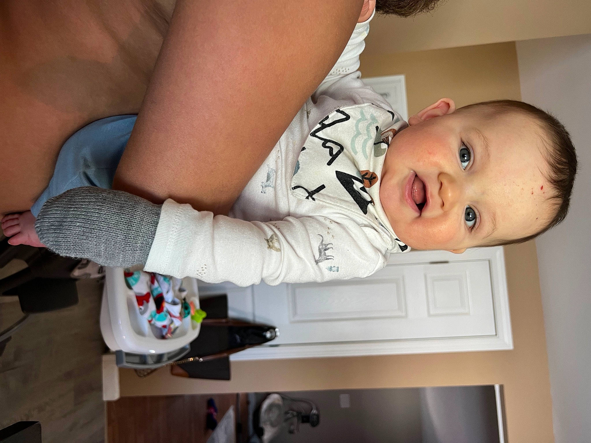 Emmanuel is registered to the contest to win money with this photo: arm, baby, baby_toddler_clothing, child, comfort, dress, elbow, facial_expression, finger, hand, happy, human_body, mouth, nose, person, skin, sleeve, smile, standing, thigh