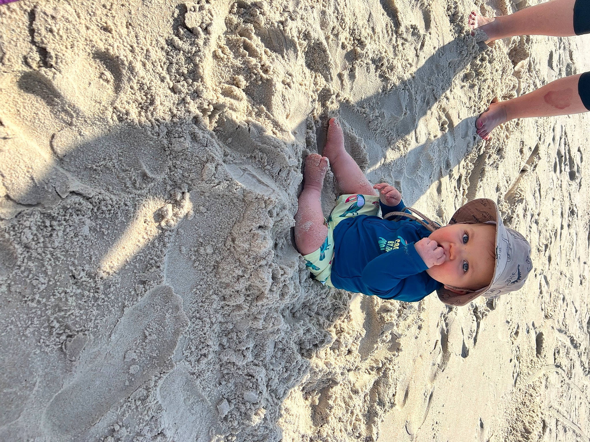 Emmanuel is registered to the contest to win money with this photo: adventure, beach, electric_blue, fun, geology, happy, headwear, human_leg, landscape, leg, leisure, outdoor_recreation, people_in_nature, person, recreation, rock, sand, shorts, smile, soil