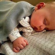 Dashiell joined the competition — help win amazing prizes! baby, sleeping, blanket, hand, bed, sheet, infant, peaceful, soft, cozy, face, resting, child, closeup, pajamas, indoors, cute, portrait, newborn, nap