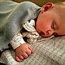 baby, sleeping, blanket, hand, bed, sheet, infant, peaceful, soft, cozy, face, resting, child, closeup, pajamas, indoors, cute, portrait, newborn, nap
