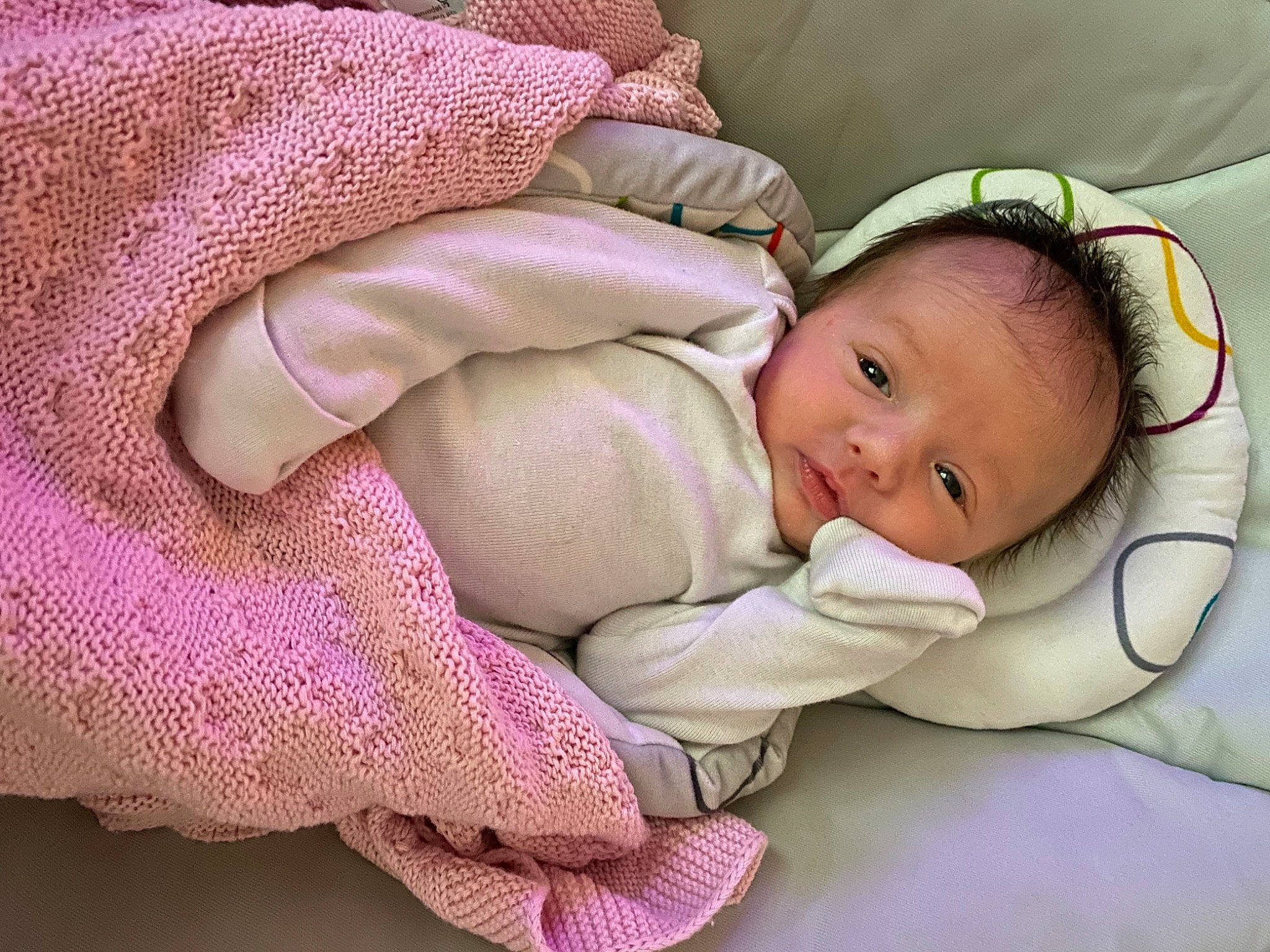 Juliet is registered to the contest to win money with this photo: baby, baby_products, baby_sleeping, baby_toddler_clothing, cheek, child, close_up, comfort, eye, finger, grass, head, linens, magenta, pattern, person, pink, skin, sleeve, thumb