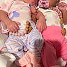 baby, infant, toddler, smiling, pacifier, cute, sleeping, cozy, blanket, pink, blue, clothing, footwear, bedtime, sleepwear, cute_expression, snuggling, happy, child, indoor