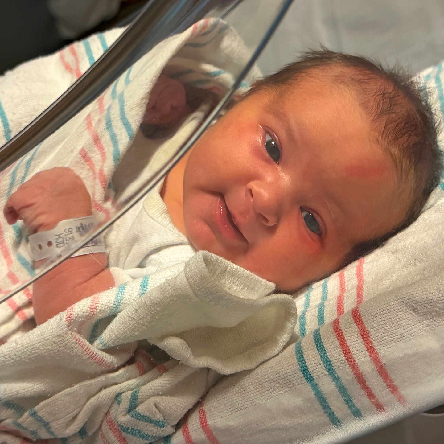 Rita is registered to the contest to win money with this photo: newborn, baby, infant, hospital, crib, blanket, wrapped, wristband, face, eyes, skin, hospital_bed, medical, patient, cute, sleeping, indoors, person, newborn_care, resting