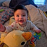 baby, bed, blanket, child, clothing, cute, duck, face, hand, happy, indoor, infant, light, person, pillow, plush, room, smiling, toy, window