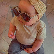 Amaya participe au concours pour gagner de l'argent avec cette photo : baby, child, sunglasses, headband, bow, fashion, cute, indoor, portrait, toddler, clothing, pants, shirt, seated, floor, tile, curious, stylish, accessory, person