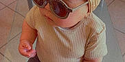 Amaya participe au concours pour gagner de l'argent avec cette photo : baby, child, sunglasses, headband, bow, fashion, cute, indoor, portrait, toddler, clothing, pants, shirt, seated, floor, tile, curious, stylish, accessory, person