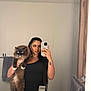 Miso is registered to the contest to win money with this photo: person, cat, mirror, bathroom, selfie, smartphone, towel, towel_rack, sink, faucet, marble_countertop, long_hair, tattoo, necklace, furry_cat, holding, reflection, wooden_frame, wall, portrait