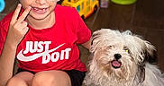 King joined the competition — help win amazing prizes! barefoot, boy, casual_clothing, child, cute, dog, floor, fluffy_dog, glasses, happy, home, indoor, peace_sign, person, pet, playful, red_shirt, short_hair, smiling, toy