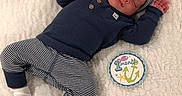 King joined the competition — help win amazing prizes! baby, infant, sleeping, one_month, milestone_card, striped_clothing, navy_blue, hat, socks, blanket, soft_texture, cute, peaceful, newborn, portrait, child, love, heart_emoji, lying_down, cozy
