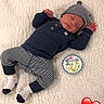 baby, infant, sleeping, one_month, milestone_card, striped_clothing, navy_blue, hat, socks, blanket, soft_texture, cute, peaceful, newborn, portrait, child, love, heart_emoji, lying_down, cozy