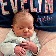 Evelyn is registered to the contest to win money with this photo: newborn, baby, sleeping, infant, hands, face, pillow, blanket, clothing, soft, cute, peaceful, portrait, indoors, child, person, resting, cozy, toddler, babywear
