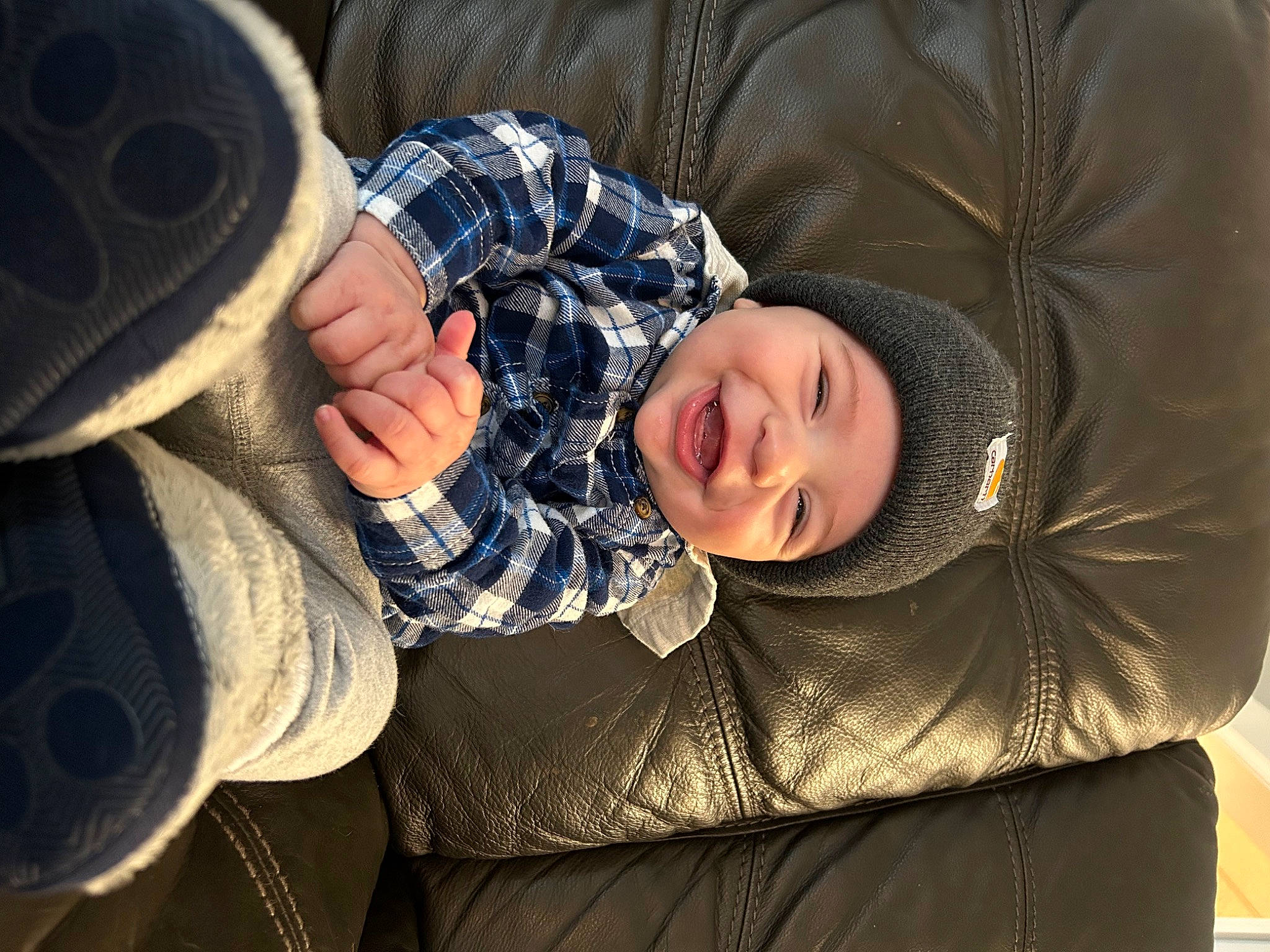 Logan joined the competition — help win amazing prizes! automotive_tire, baby, child, comfort, couch, fashion_accessory, flash_photography, fun, gesture, glasses, hat, headwear, joy, pattern, person, plaid, sitting, sleeve, smile, textile