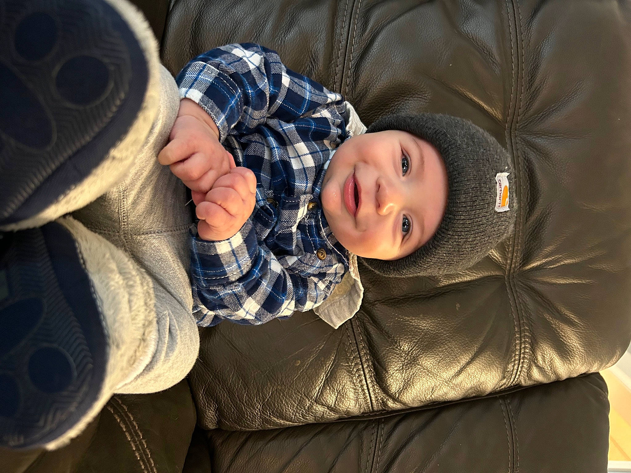 Logan joined the competition — help win amazing prizes! baby, child, comfort, couch, fashion_accessory, fedora, flash_photography, hat, headgear, headwear, joy, pattern, person, plaid, sitting, sleeve, smile, sun_hat, tartan, textile