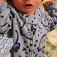 Ronald joined the competition — help win amazing prizes! baby, newborn, sleeping, hat, onesie, blue, patterned_clothing, blanket, floral, infant, cute, peaceful, sleep, small_hands, portrait, indoors, cozy, child, resting, soft_fabric