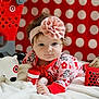 baby, headband, flower, plush_toy, blanket, shopping_basket, snack_box, red, white, polka_dot, toy, child, cute, indoor, soft, playful, infant, clothing, portrait, cozy