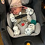 baby, car, car_interior, carseat, clothing, face, hat, head, infantbed, person, transportation, vehicle, yawning