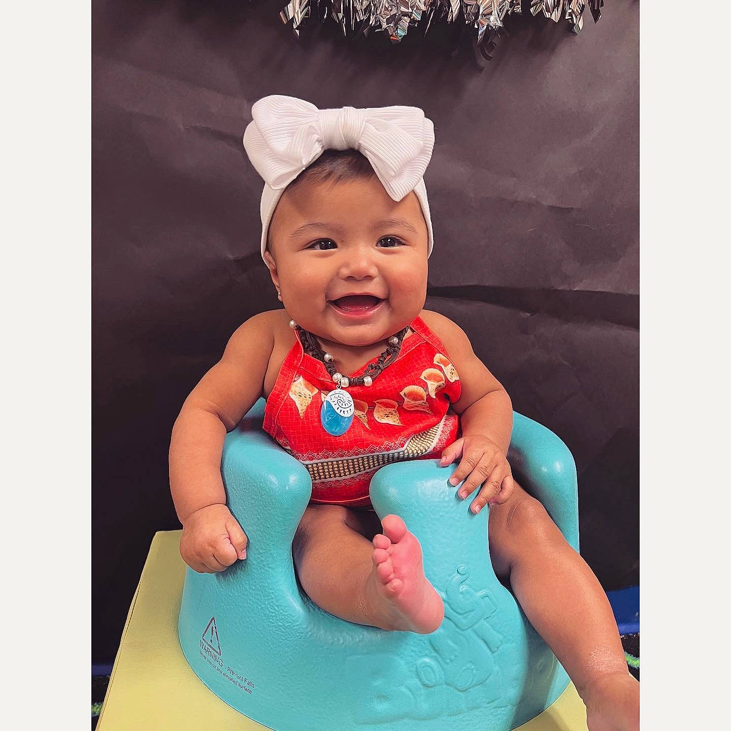 Cataleya is registered to the contest to win money with this photo: arm, baby, baby_products, baby_toddler_clothing, costume_hat, electric_blue, event, font, happy, head, human_body, nail, party_supply, person, pink, sitting, sleeve, smile, t_shirt, thumb