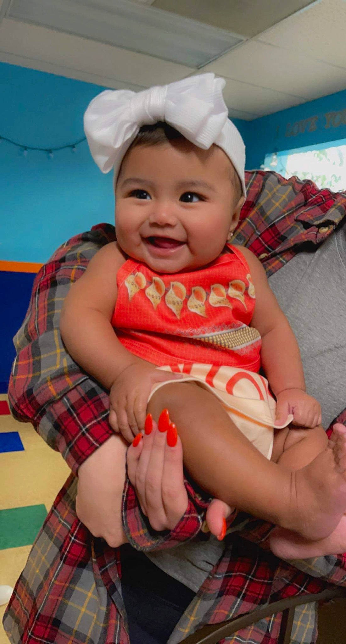 Cataleya joined the competition — help win amazing prizes! baby_toddler_clothing, comfort, face, finger, fun, happy, head, headgear, headwear, human_body, joy, lap, leg, person, pink, plaid, product, red, skin, smile