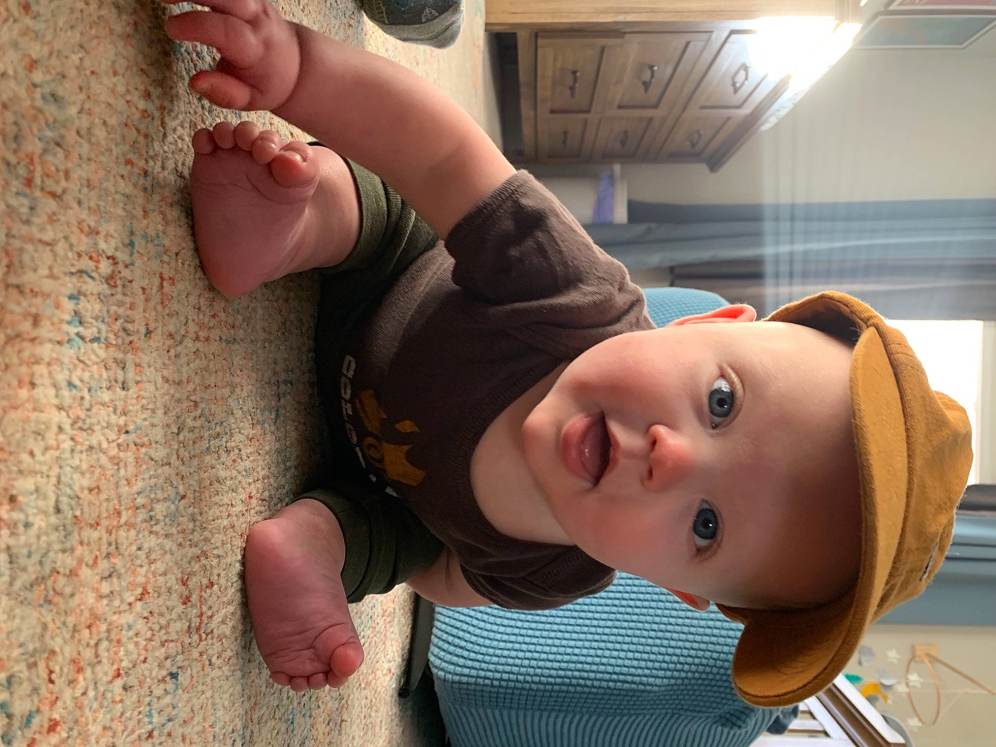 Bo is registered to the contest to win money with this photo: baby, baby_toddler_clothing, cap, child, eyewear, fashion_accessory, foot, fun, gesture, happy, hat, human_leg, nose, person, skin, sun_hat, surprise, thumb, toddler, toe