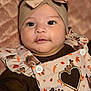 baby, headband, bow, turkey, autumn_leaves, quilt, clothing, portrait, cute, infant, face, child, apparel, pattern, fabric, closeup, soft_lighting, smile, young, indoor