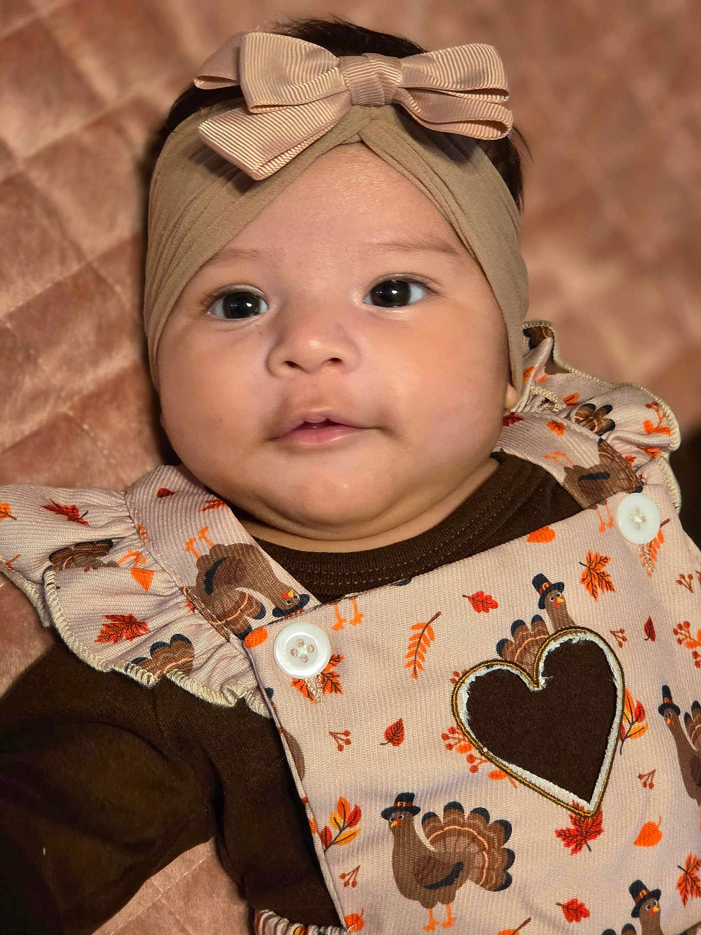 Adhara joined the competition — help win amazing prizes! baby, headband, bow, turkey, autumn_leaves, quilt, clothing, portrait, cute, infant, face, child, apparel, pattern, fabric, closeup, soft_lighting, smile, young, indoor