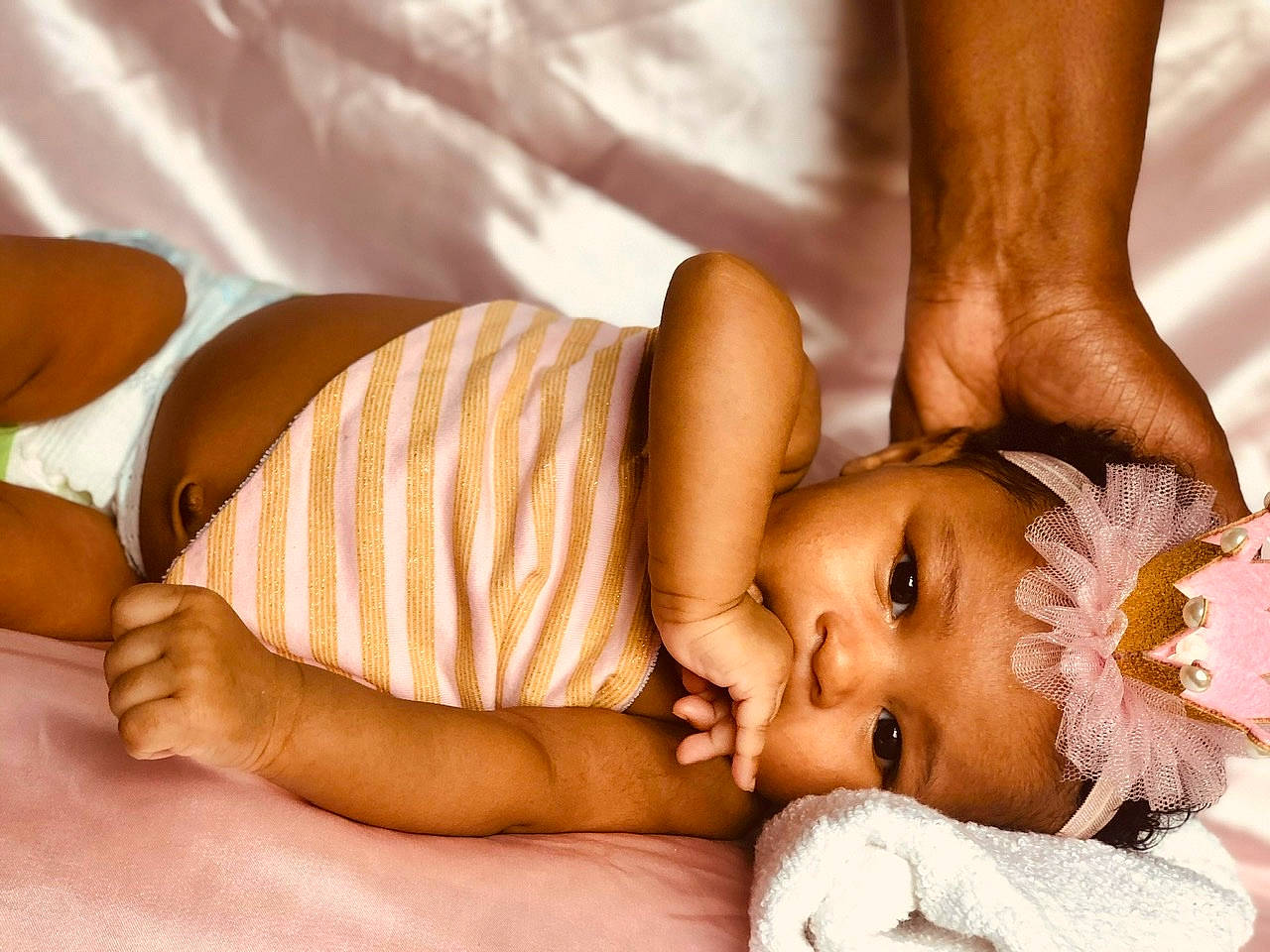 Ashanti is registered to the contest to win money with this photo: baby, baby_sleeping, black_hair, child, finger, hand, headwear, leg, muscle, person, skin, stomach